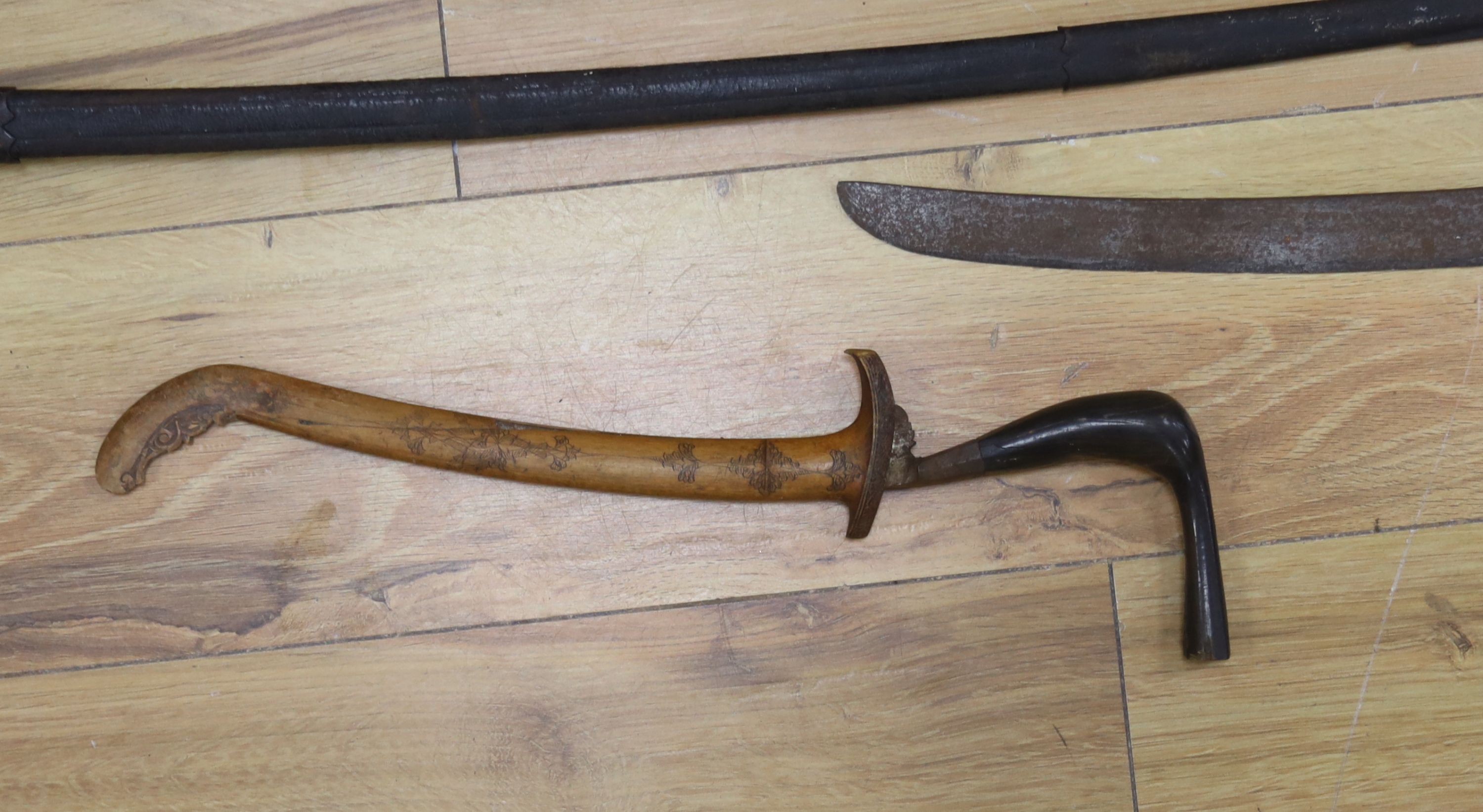 A Dutch East Indies short sword / kris having horn handle and gold inlay, another similar, a late 19th century sword and scabbard, an epee and another sword (5)
